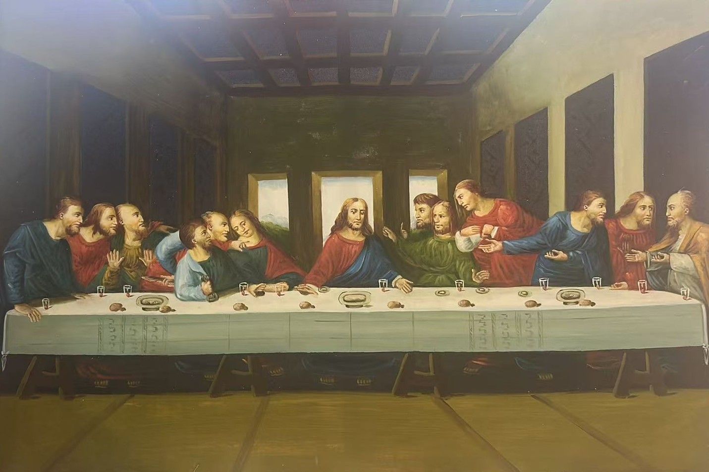 A hand-painted copy of the Last Supper with thirteen figures seated around a long table.