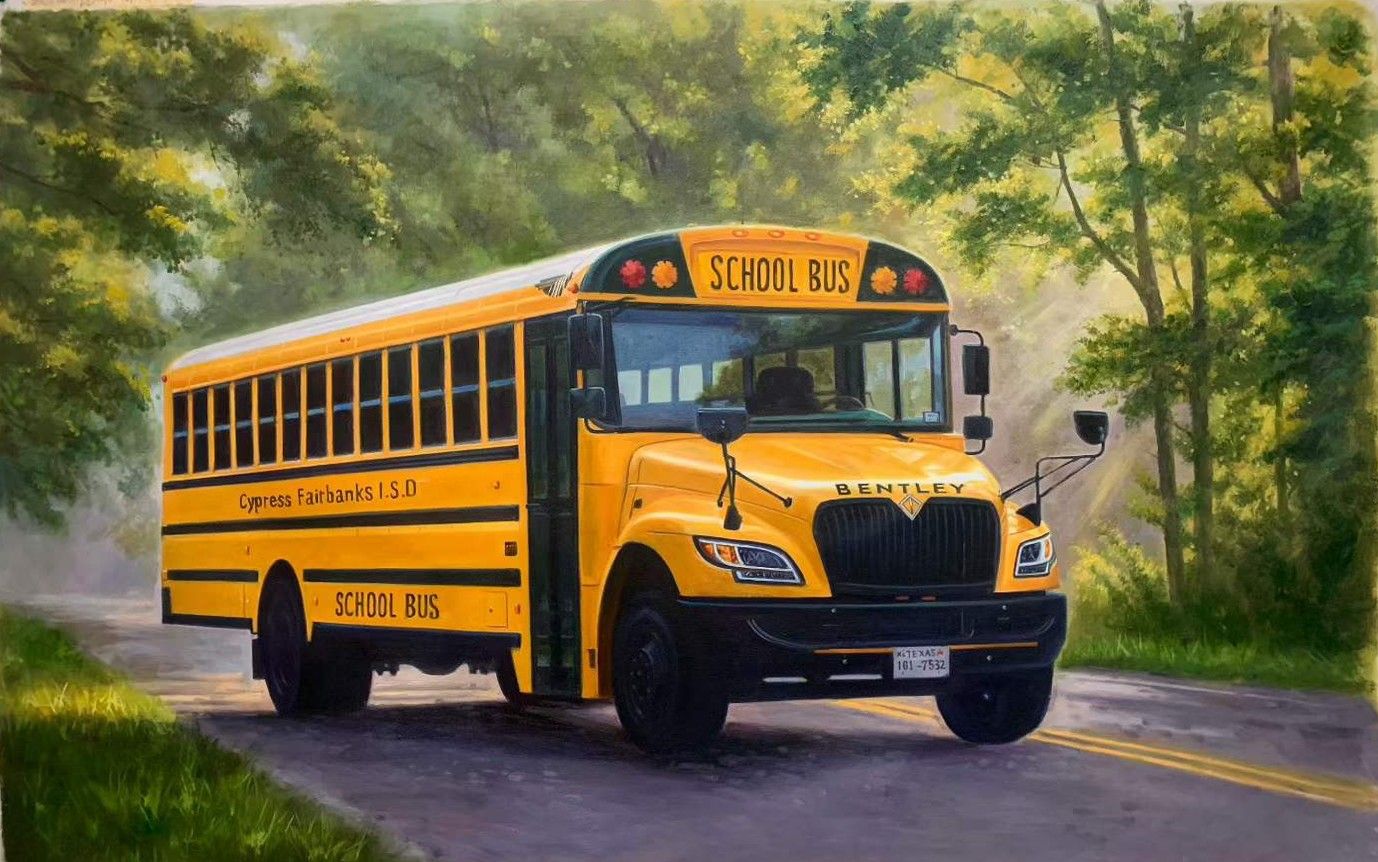 A yellow school bus on a tree-lined road.