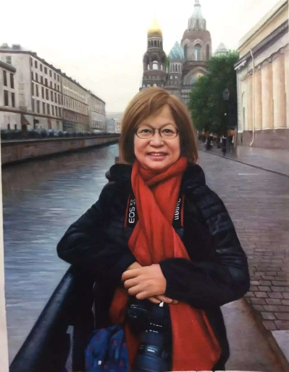 A woman with a camera and red scarf beside a canal in St Petersburg.