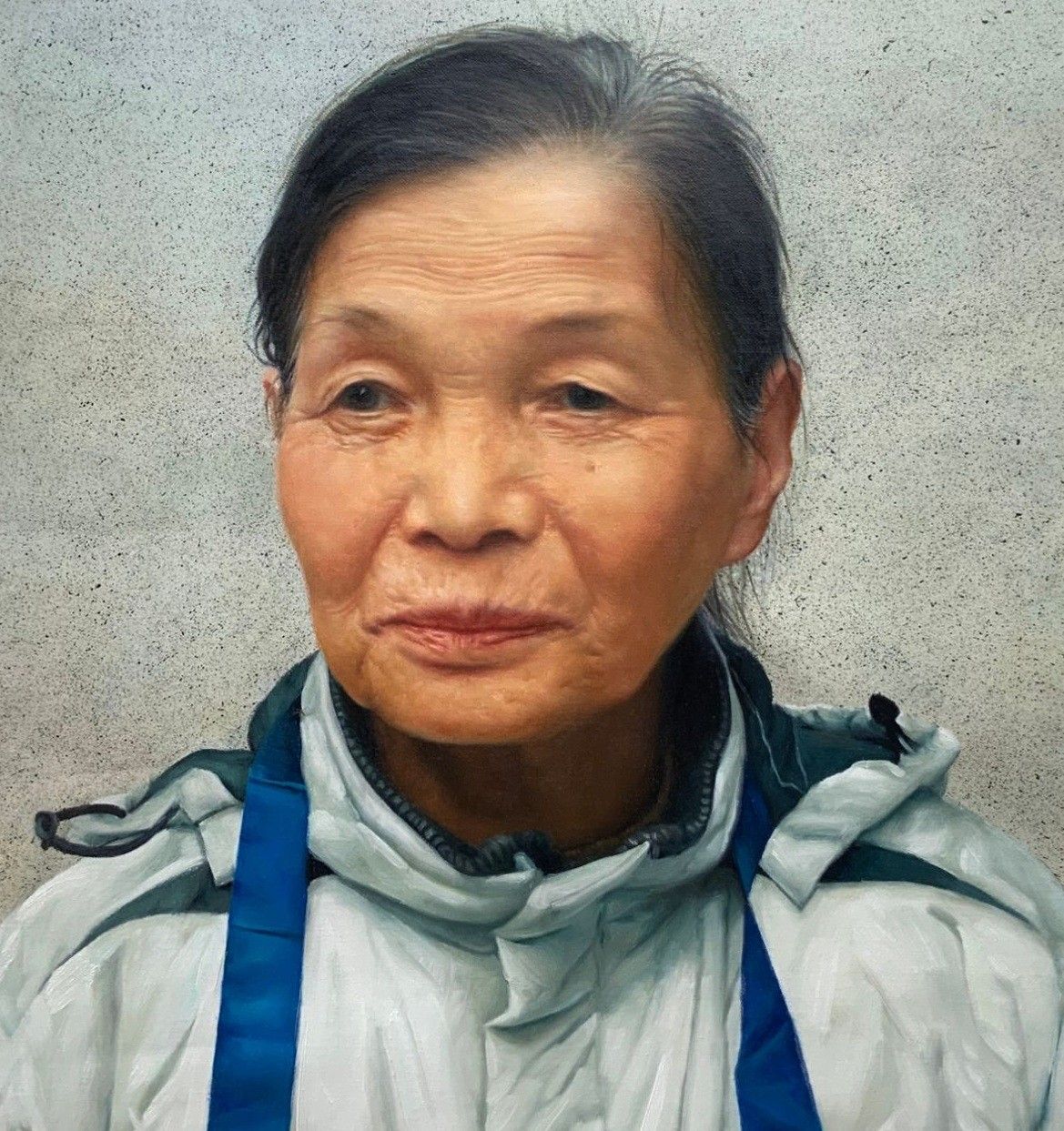 Hand-painted portrait of an older woman in a pale work jacket and blue apron, against a speckled grey wall.